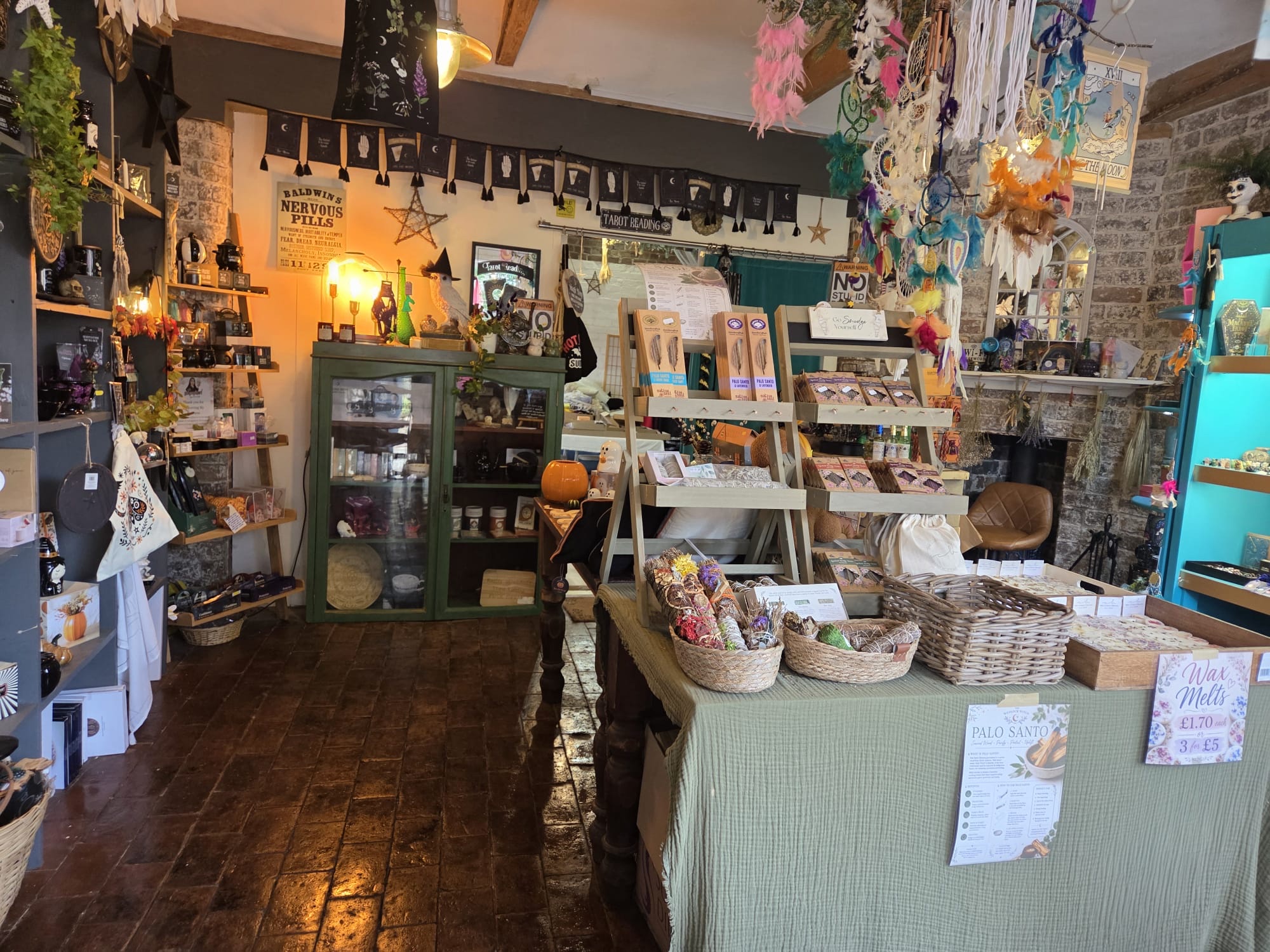 Warmly lit magical shelves inside The Wenlock Witch